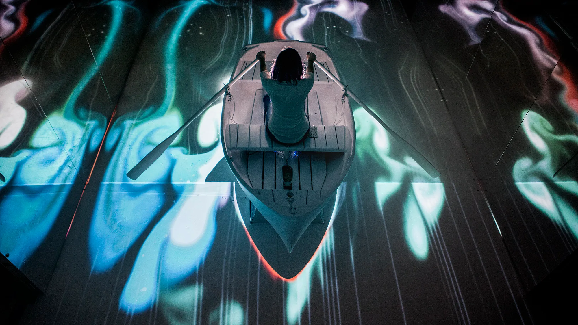 An immersive experience where you sit in a real boat and row through a digital world projetion mapped to the floor.