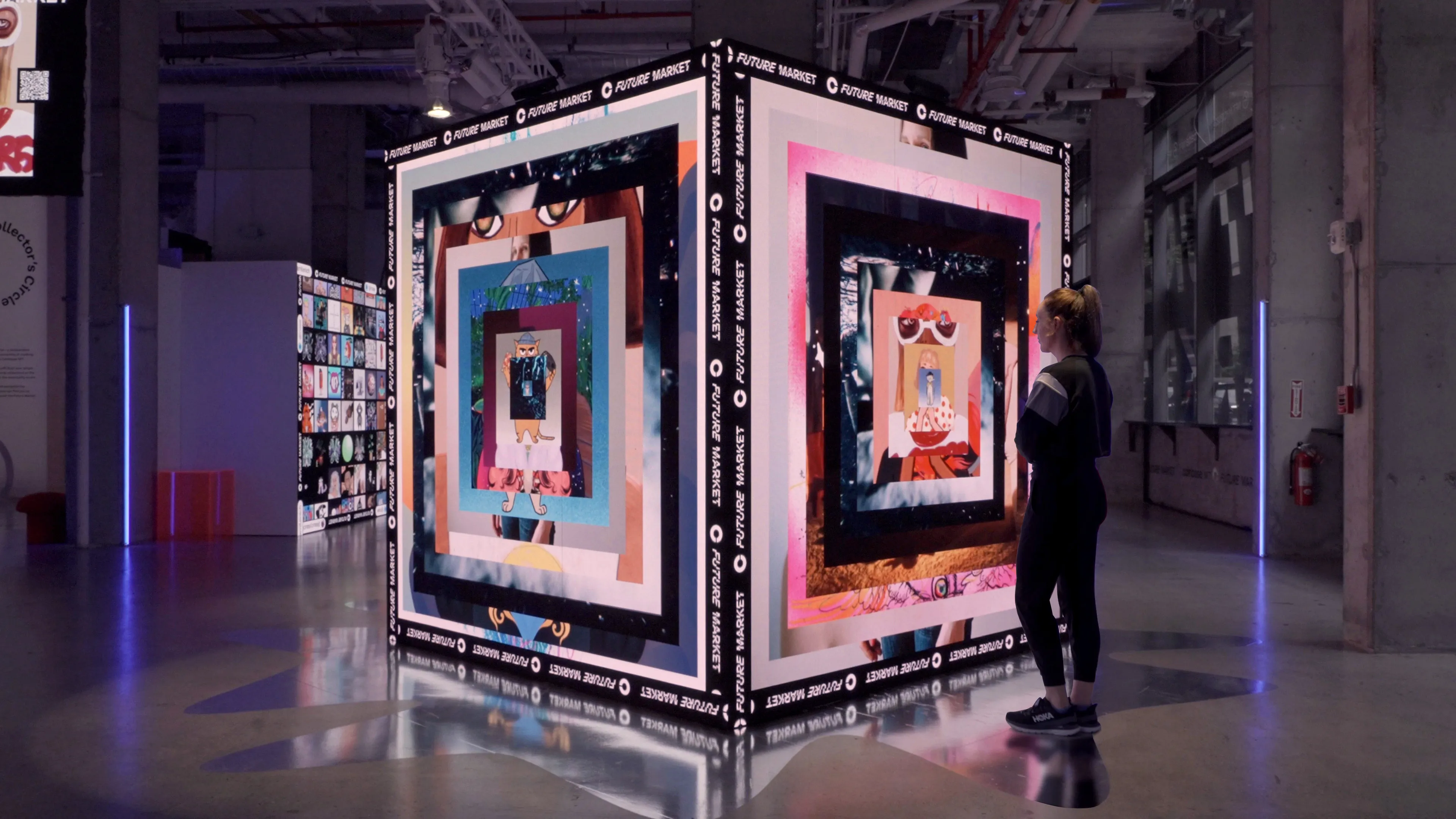 A woman interacts with a digital installation featuring multiple LED screens that showcase digital NFT art. This exhibition, powered by Coinbase for the NFT NYC event, captures the fusion of art and blockchain innovation.